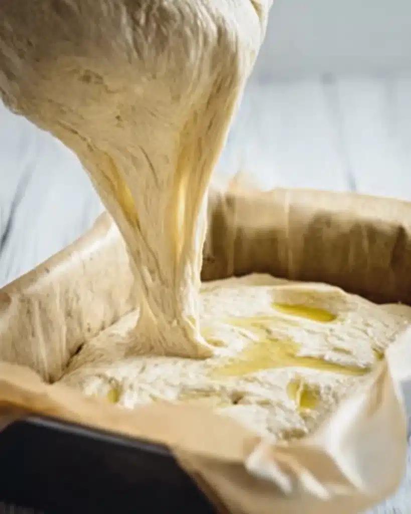 Quick and Dirty Focaccia 4 Stretchy focaccia dough poured into parchment-lined pan