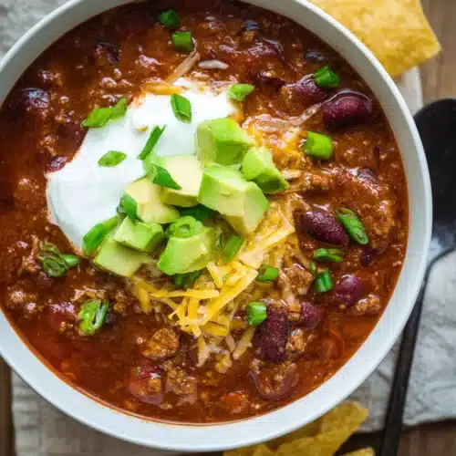 Slow Cooker Chili Recipe 7 Bowl of slow cooker chili with sour cream, avocado, and cheese