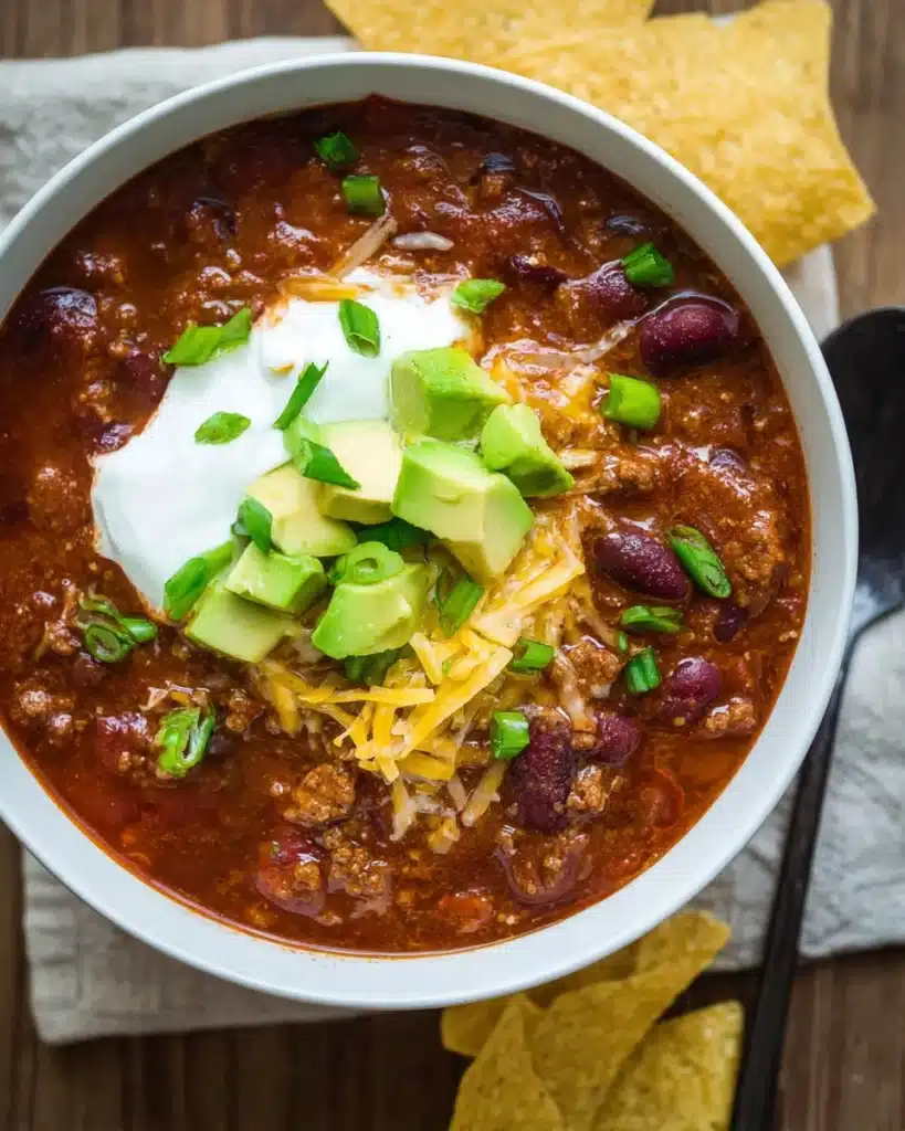 Slow Cooker Chili Recipe 1 Bowl of slow cooker chili with sour cream, avocado, and cheese