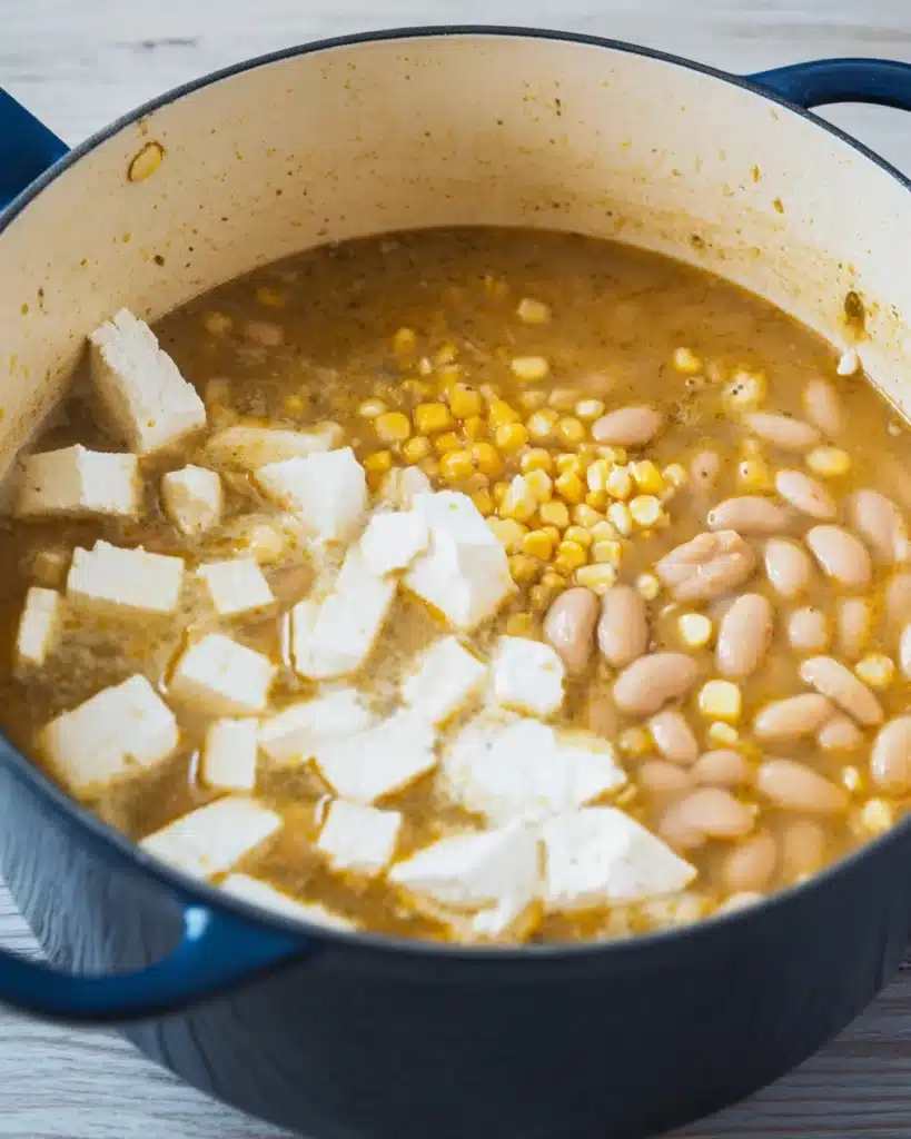 The Best White Chicken Chili (Creamy, Flavorful & Easy Recipe) 5 Cream cheese, beans, and corn in broth for white chicken chili