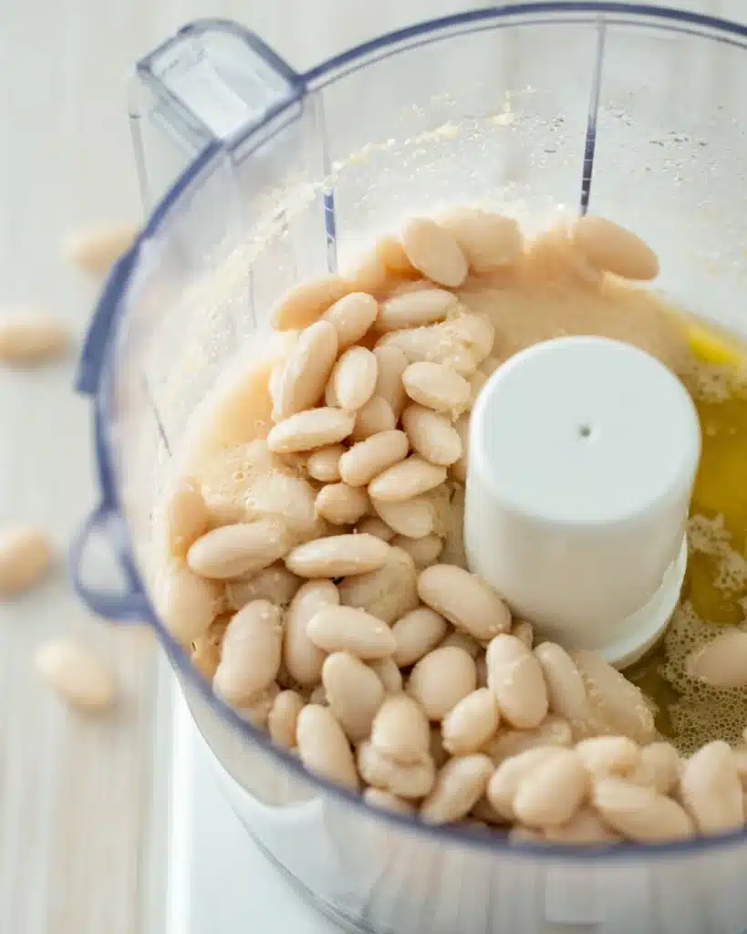 The Best White Chicken Chili (Creamy, Flavorful & Easy Recipe) 4 Cannellini beans and broth in a food processor ready to blend