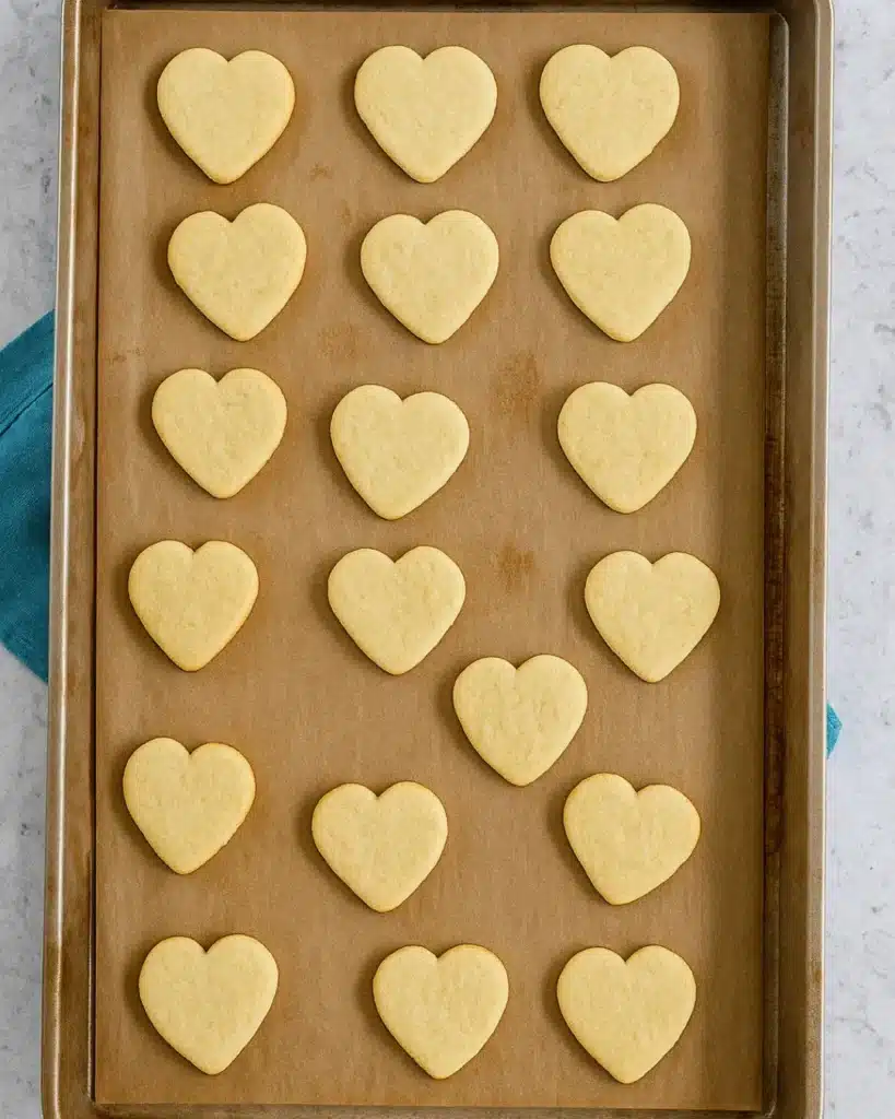 Shortbread Cookie Recipe 5 Heart-shaped shortbread cookies on parchment-lined baking sheet