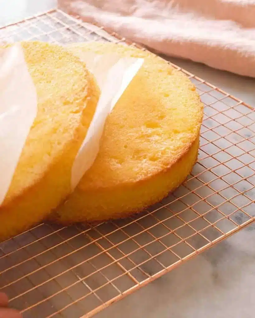 Removing parchment paper from cooled cake layer on wire rack