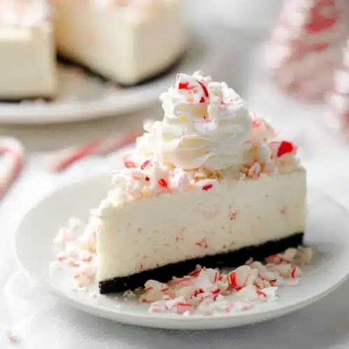 White Chocolate Peppermint Cheesecake 6 Slice of white chocolate peppermint cheesecake topped with whipped cream and crushed candy canes
