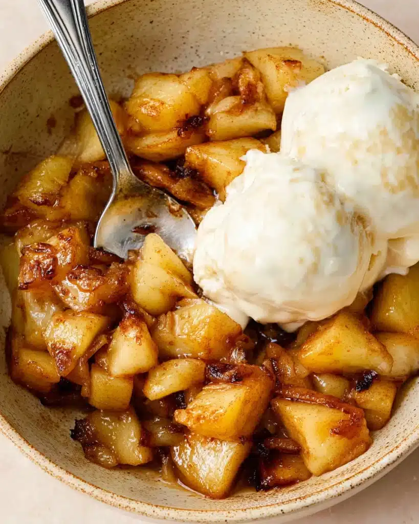 Warm caramelized air fryer apples served with vanilla ice cream