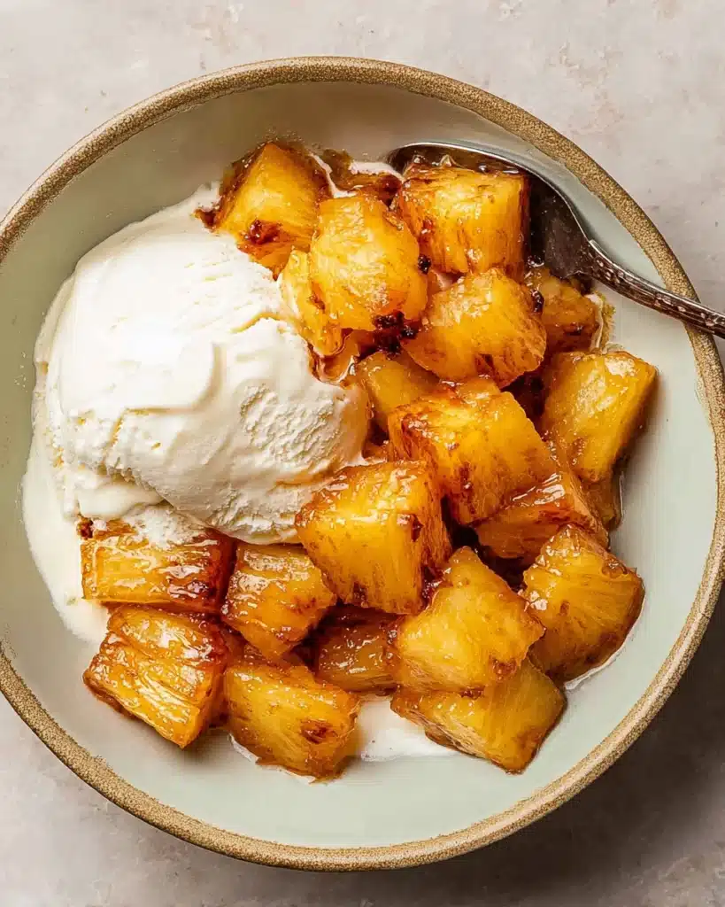 AIR FRYER PINEAPPLE (CARAMELIZED AND SWEET IN MINUTES) 4 Caramelized air fryer pineapple served over vanilla ice cream