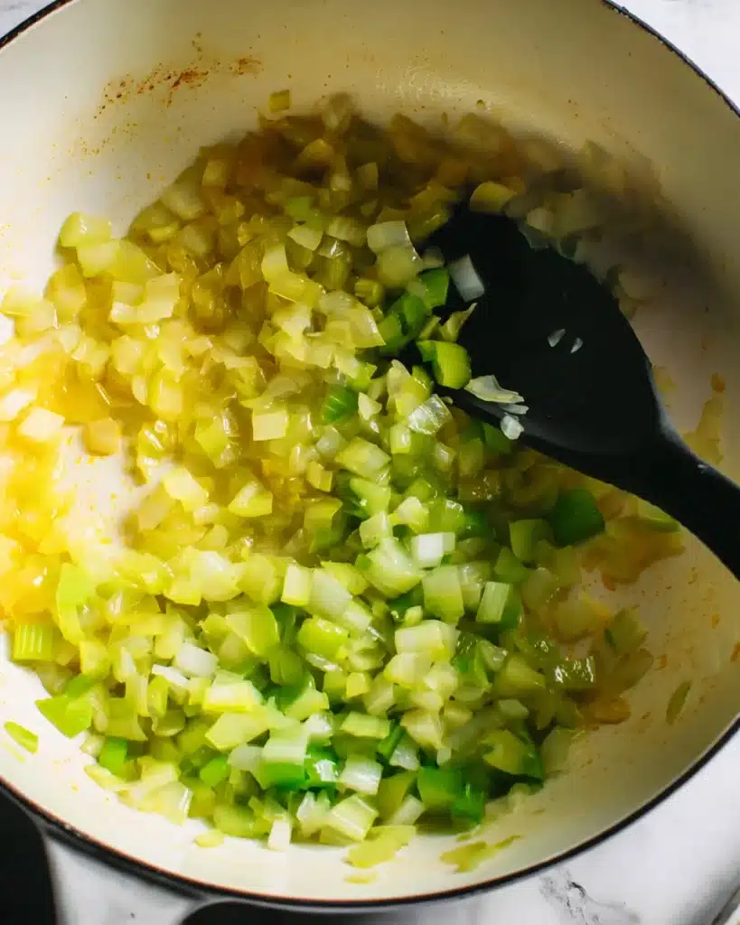 Avgolemono Soup (Greek Lemon Chicken & Rice Soup) 2 Sautéed onions and celery for Avgolemono Soup in white pot