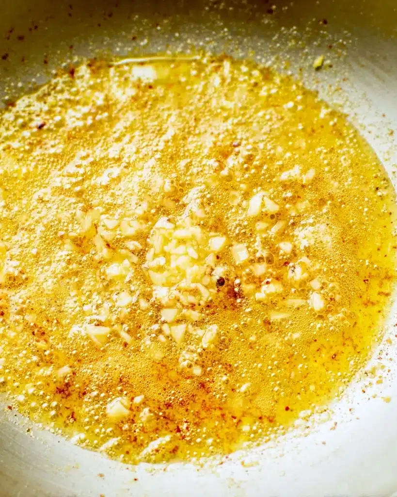 Baked Chicken Thighs (Creamy Garlic Butter Style) 3 Garlic sautéing in butter for baked chicken thighs sauce