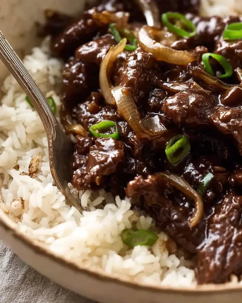 Beef stir fry with honey pepper sauce served over rice in a bowl