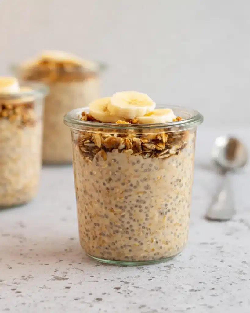 Creamy brown sugar overnight oats in glass jar topped with banana slices and granola