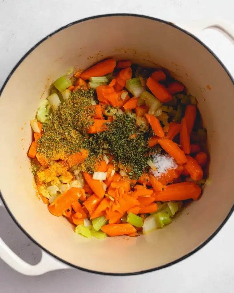 Chicken Bacon Rice Soup (Creamy, Hearty & Easy Recipe) 5 Sautéed carrots and celery with garlic and herbs in a Dutch oven