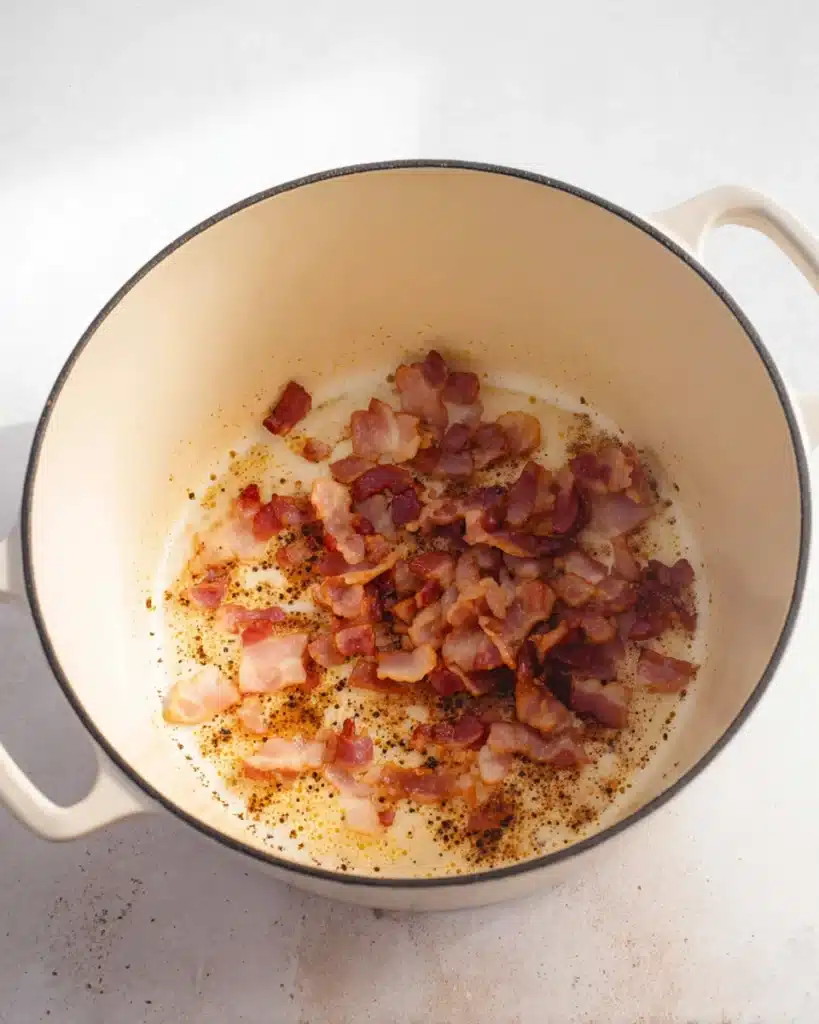 Chicken Bacon Rice Soup (Creamy, Hearty & Easy Recipe) 3 Crispy bacon pieces cooking in a Dutch oven for chicken bacon rice soup