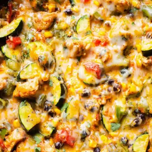 Cheesy chicken and zucchini skillet with corn, beans, and melted Tex-Mex cheese