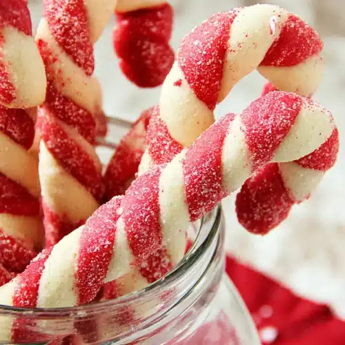 Christmas Candy Cane Cookies Recipe 4 Christmas Candy Cane Cookies in a glass jar with peppermint sugar topping