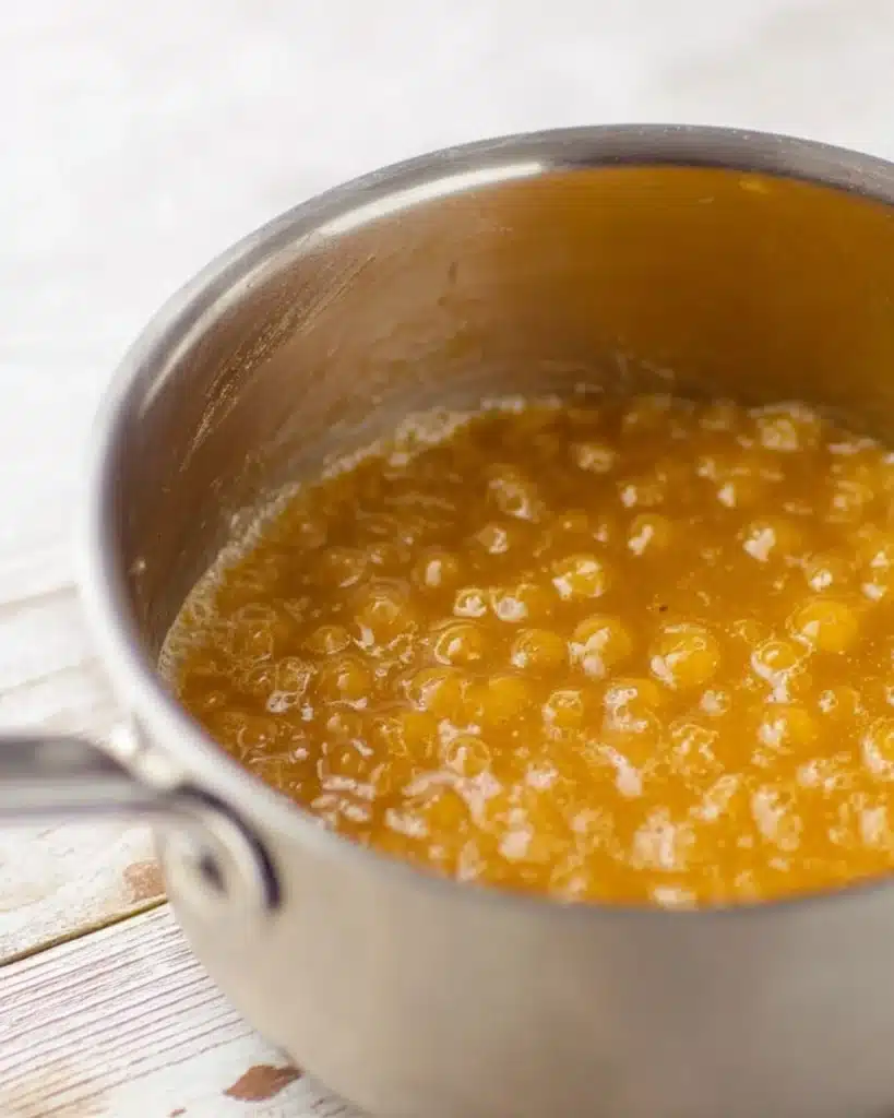 Bubbling golden toffee mixture in saucepan for Christmas Crack