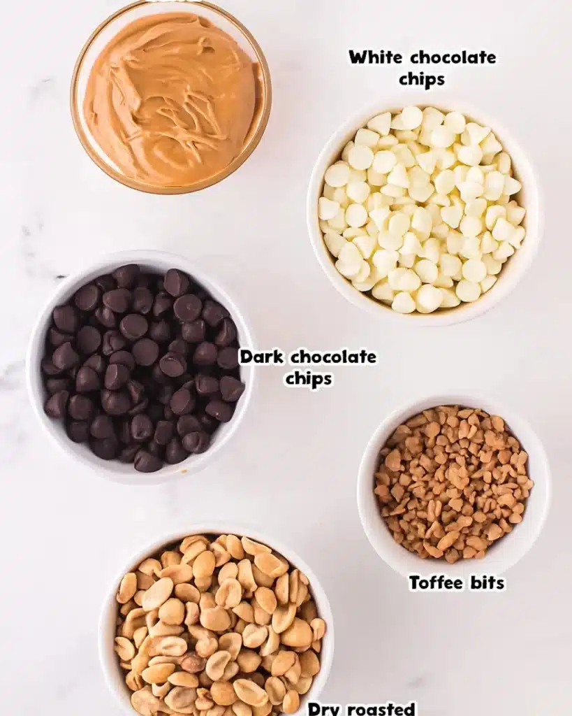 Ingredients for Christmas Crock Pot Candy in small bowls on marble surface