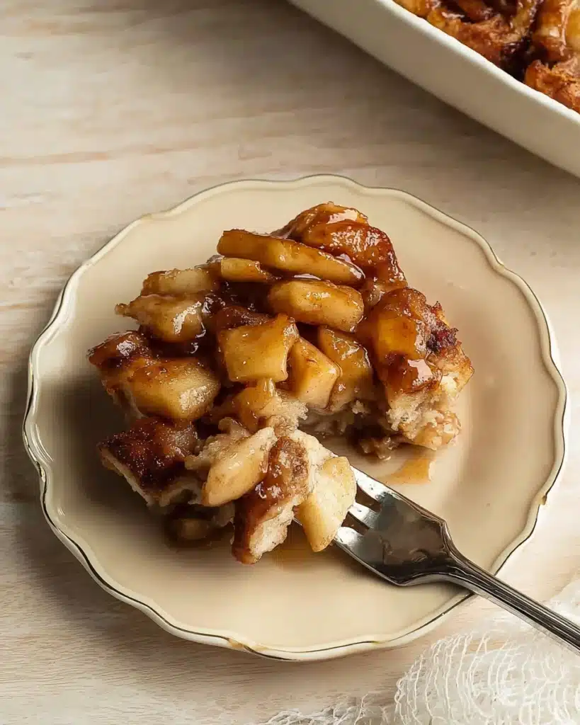 Plated serving of cinnamon rolls and apple pie filling with caramelized apples