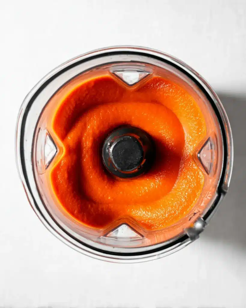 Blended creamy tomato soup in a glass blender