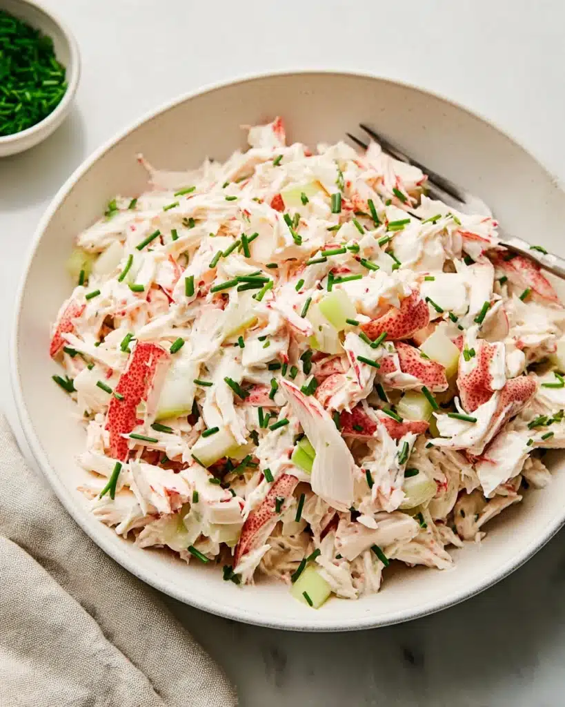 Creamy crab salad served with crackers and lettuce leaves
