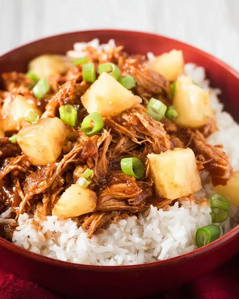 Hawaiian BBQ chicken with pineapple and rice in a red bowl
