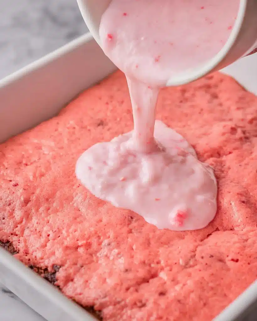 Easy Strawberry Brownies 3 Pouring strawberry glaze over freshly baked strawberry brownies