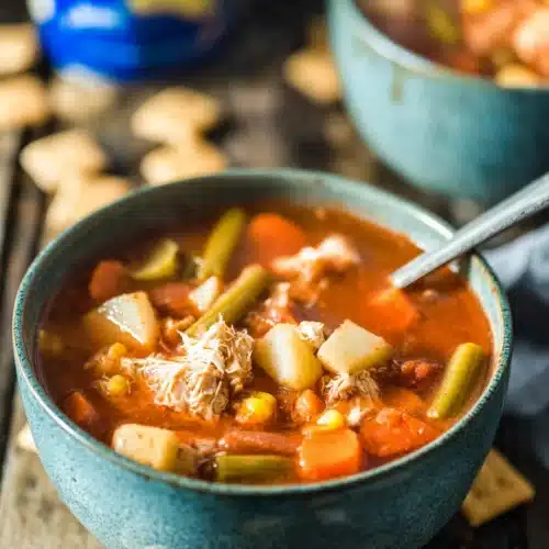Maryland Crab Soup 6 Hearty Maryland crab soup with vegetables in a blue bowl on a rustic wooden table
