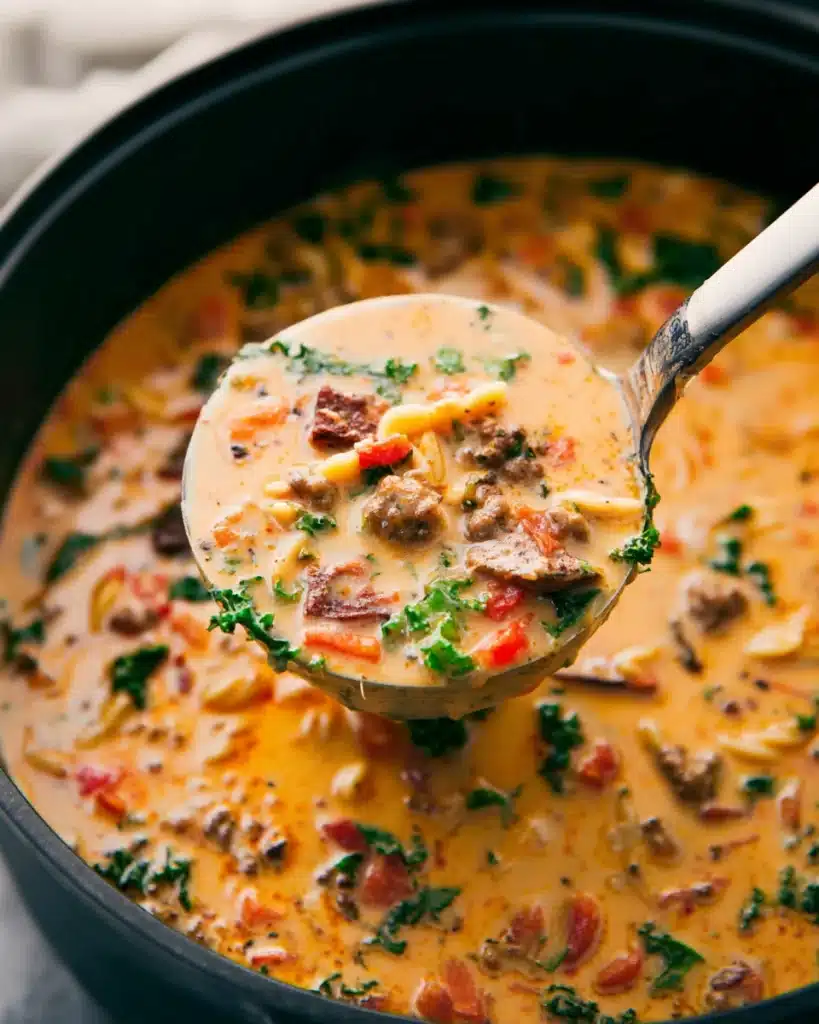 Sausage Pasta Soup (Creamy and Hearty One-Pot Meal) 6 Ladle of creamy sausage pasta soup with kale and carrots