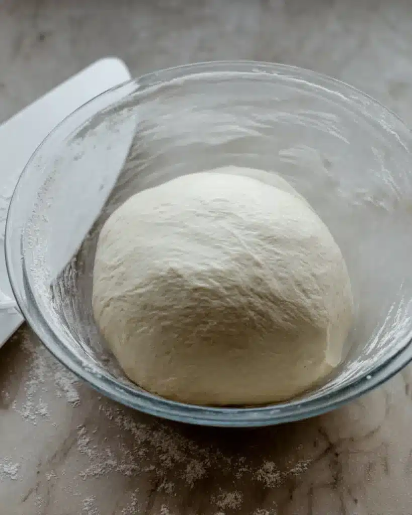 Sourdough Discard Star Bread – A Festive Christmas Showstopper 2 Sourdough discard star bread dough in glass bowl with scraper