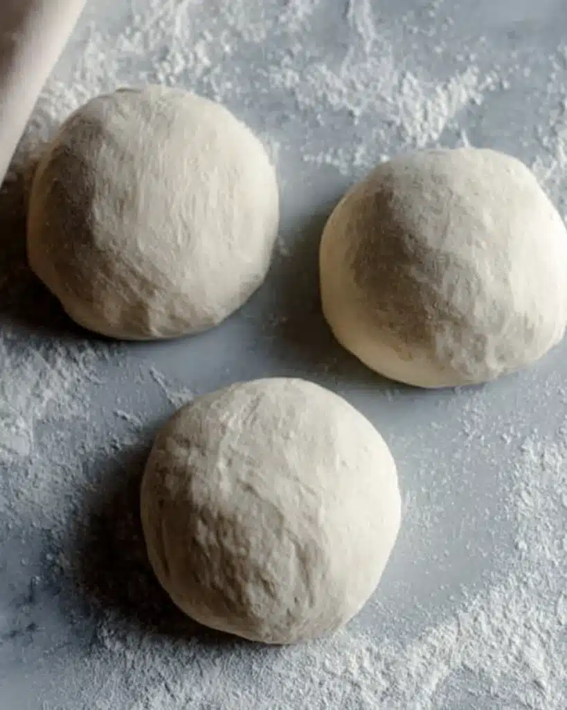 Sourdough Discard Star Bread – A Festive Christmas Showstopper 3 Three sourdough discard star bread dough balls on floured marble surface