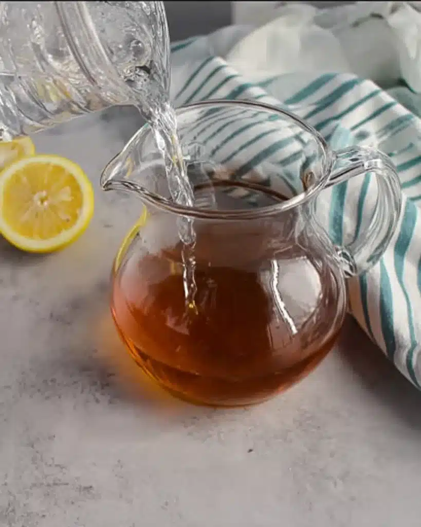 Sweet Tea Recipe – The Perfect Refreshing Southern Drink 3 Pouring cold water into glass pitcher of sweet tea