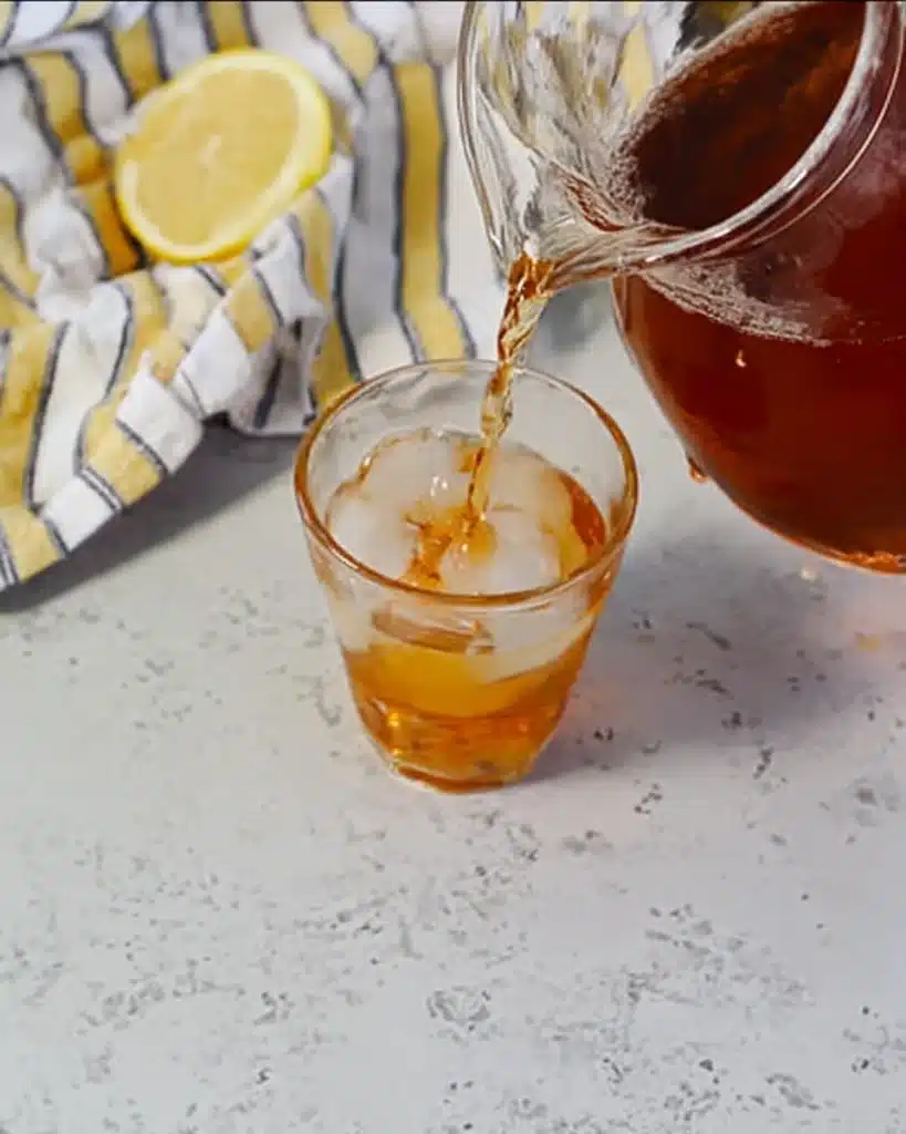 Sweet Tea Recipe – The Perfect Refreshing Southern Drink 4 Pouring sweet tea over ice from glass pitcher