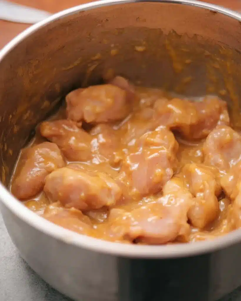 Marinated chicken coated in glossy sauce for sweet and sour chicken recipe