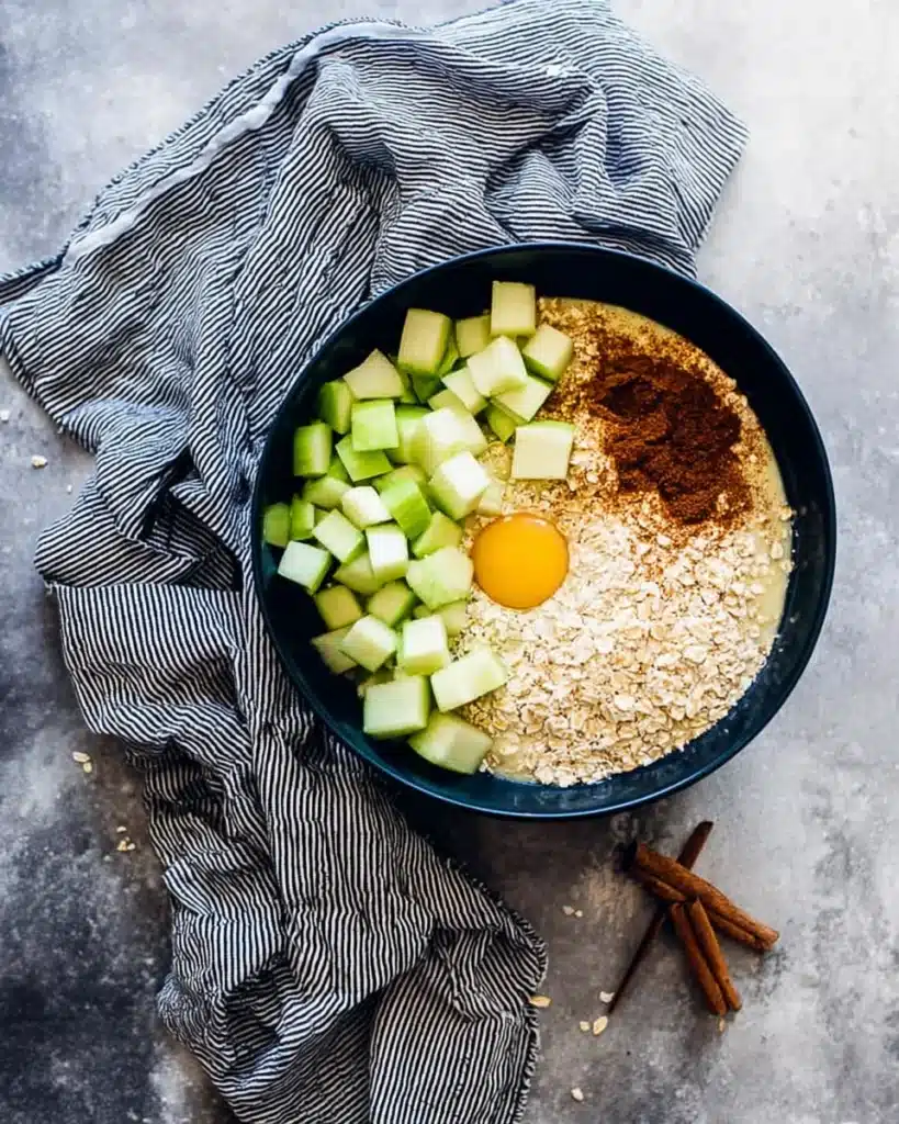 Cinnamon Apple Oatmeal Muffins 2 Cinnamon apple oatmeal muffin batter ingredients in a bowl before mixing