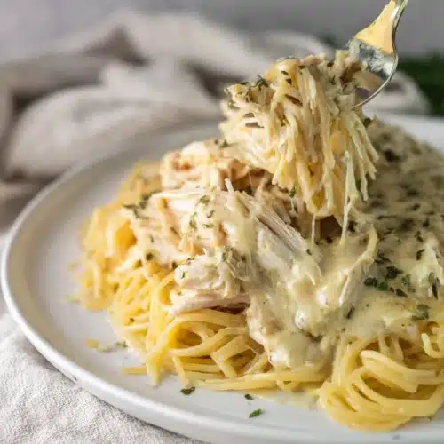 Creamy Crockpot Angel Chicken with pasta and sauce on a plate