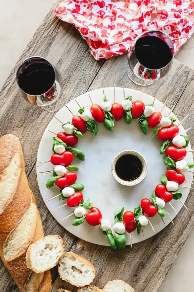 Heart shaped Caprese skewers with bread, wine, and balsamic for Valentine’s Day