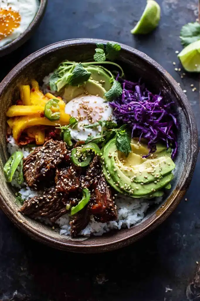 Korean BBQ steak rice bowl with avocado, cabbage, and poached egg