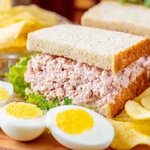Old-Fashioned Bologna Salad 6 Old-fashioned bologna salad sandwich with boiled eggs and chips on a plate