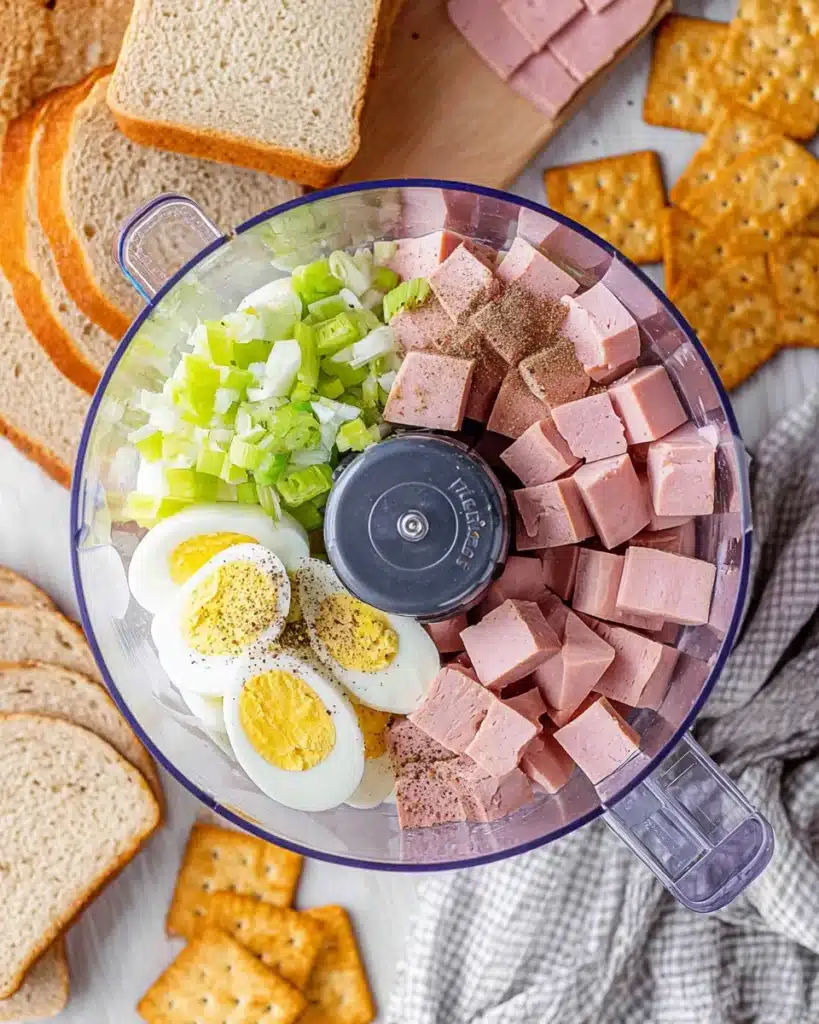 Old-Fashioned Bologna Salad 2 Old-fashioned bologna salad ingredients in a food processor ready to blend
