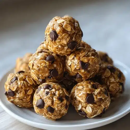 Peanut butter energy bites with oats and chocolate chips on a white plate