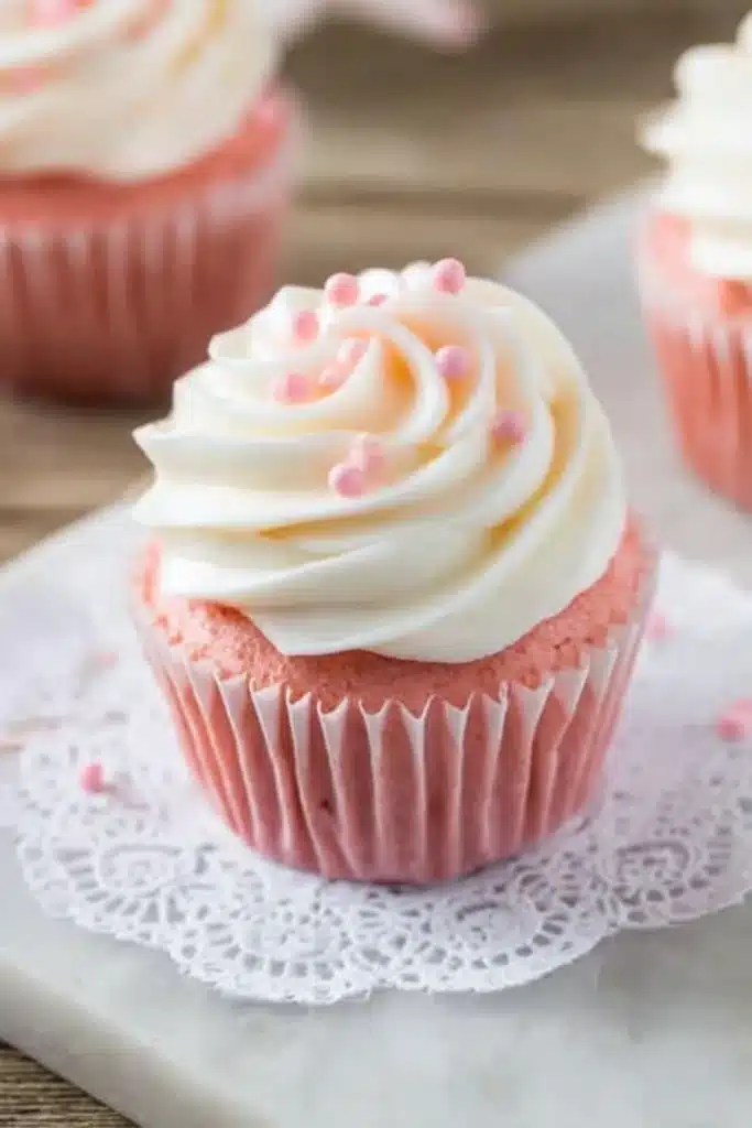 Pink Velvet Cupcakes 1 Pink velvet cupcake with white frosting and pink pearls on lace doily