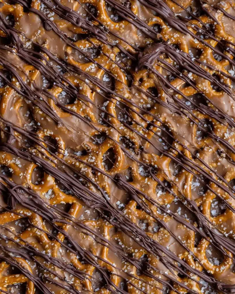 Salted caramel pretzel bark topped with chocolate drizzle and sea salt