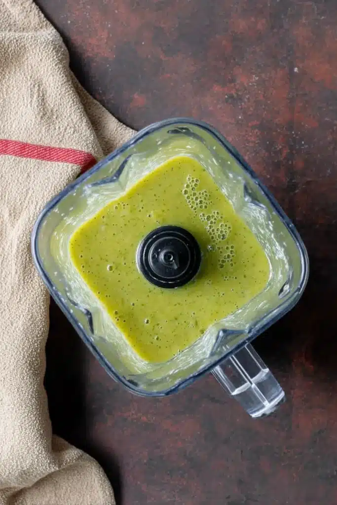 Blender with green tomatillo sauce for chicken pozole verde