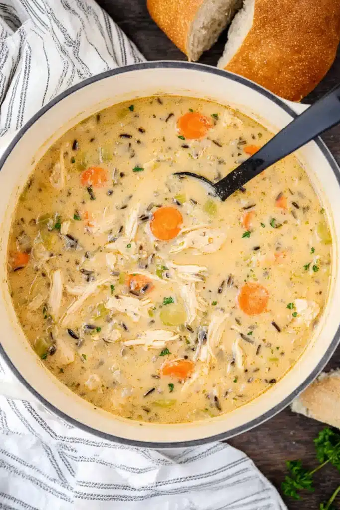 Creamy Chicken Tortilla Soup 2 Creamy chicken tortilla soup in white pot with carrots, celery, and wild rice