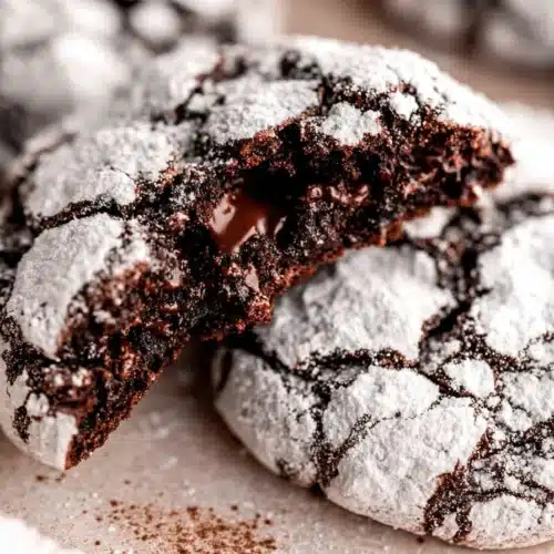 Fudgy gluten-free chocolate crinkle cookies dusted with powdered sugar