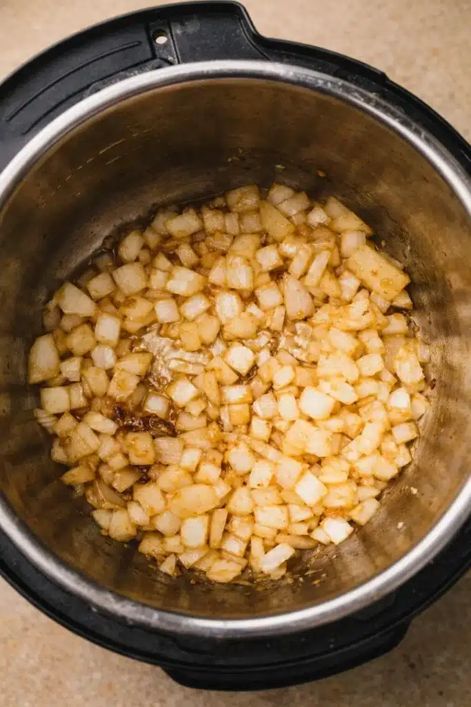 Instant Pot Beef Tips 3 Diced onions sautéing in Instant Pot for beef tips recipe