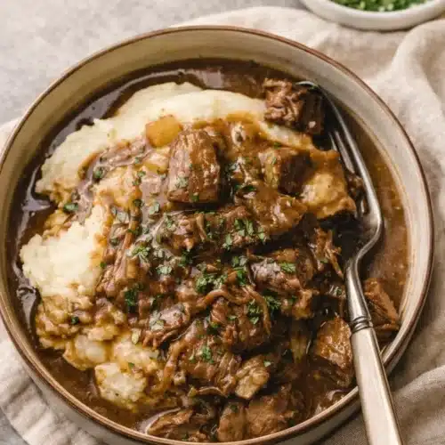 Instant Pot Beef Tips 6 Instant Pot beef tips with gravy over mashed potatoes in bowl