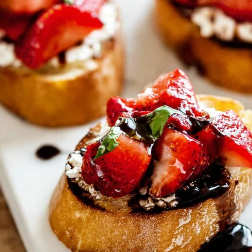 Strawberry goat cheese bruschetta with balsamic glaze and basil on toasted baguette