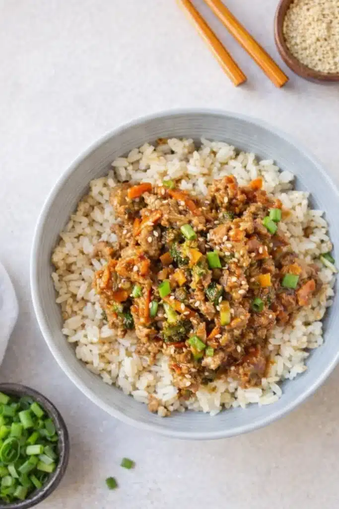 Teriyaki turkey rice bowl topped with sesame seeds and green onions