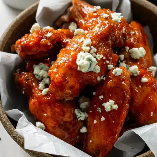 Air fryer buffalo chicken wings with honey buffalo sauce and blue cheese crumbles