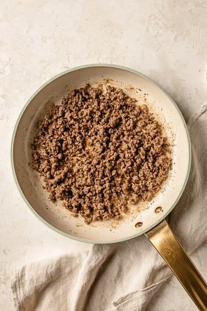Burger Bowls seasoned ground beef cooking in skillet